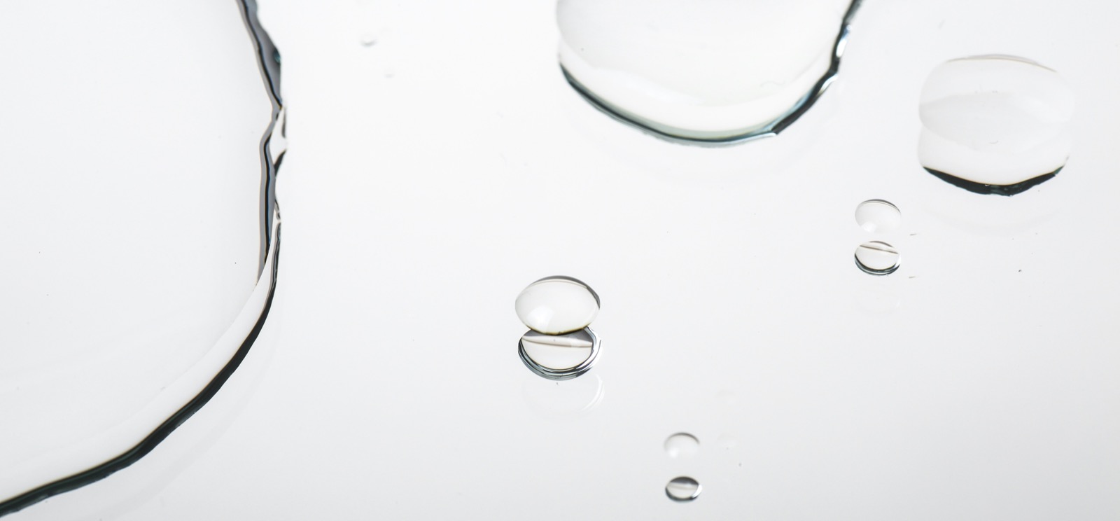 透明な水滴が広がる化粧水のイメージ